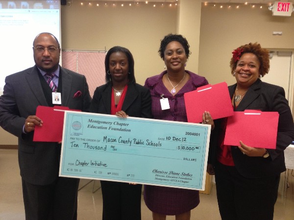In November, Dr. Melvin A. Lowe III, education coordinator for Macon County Schools, along with Jacqueline A. Brooks (2nd from r), Macon County superintendent, and Camille Floyd (r), instructor, accept a Chapter Initiative Grant for $10,000 from Charisse Stokes, director, chapter Education Foundation.